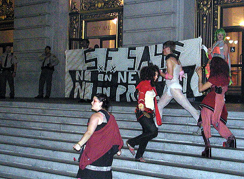 people freaking out on the steps of city hall with the "s.f. says no on newsom no on prop m" and night falls