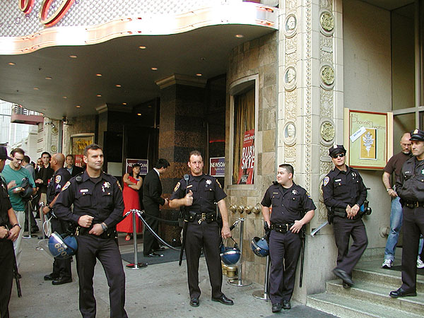a loose line of police officers relaxing in front of ruby skye