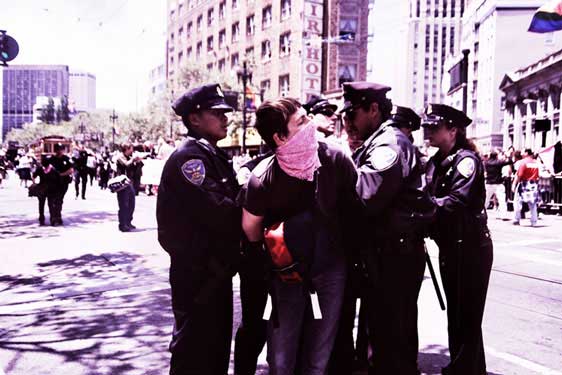 police handcuffing person in pink bandana in the market street pride parade route