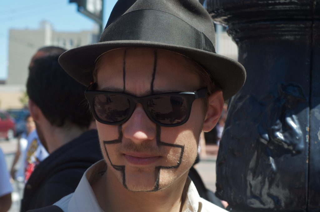 a person with an upside-down cross drawn on their face