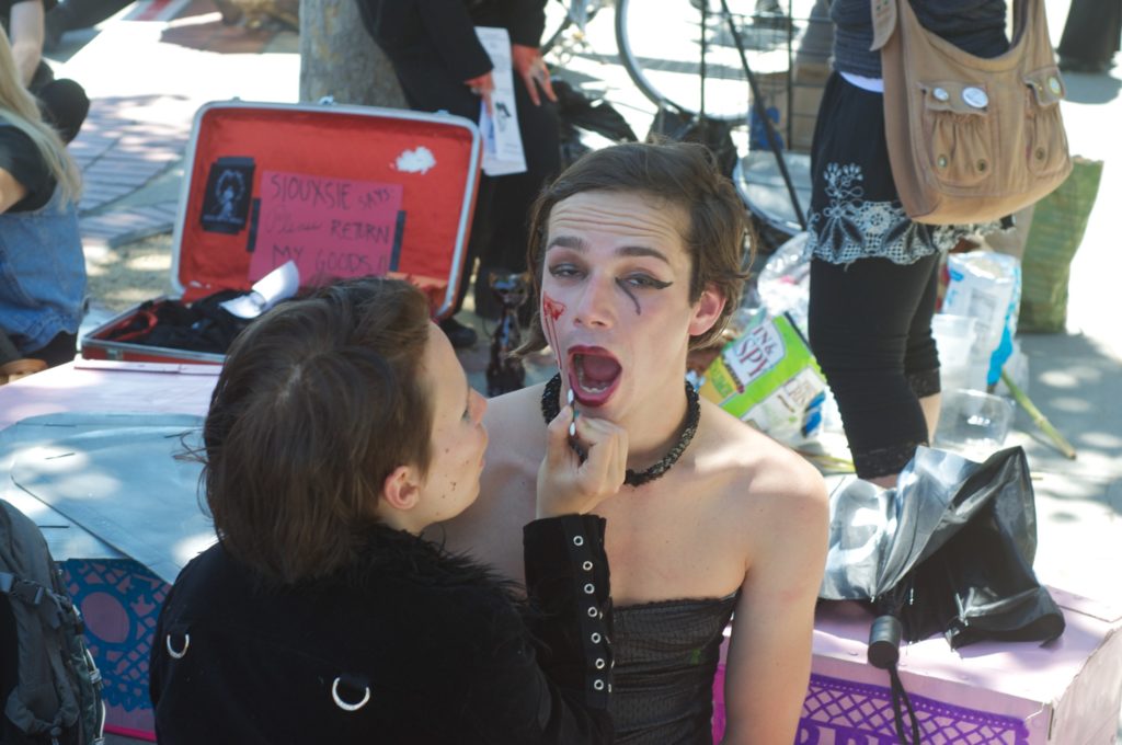 a person having goth make-up applied