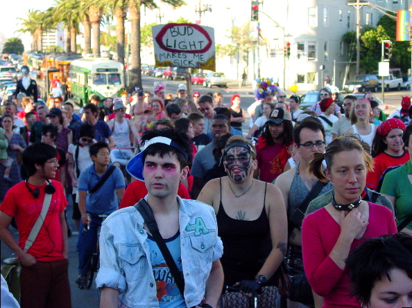a procession of about two hundred people have taken the street and are proceeding down market to the castro