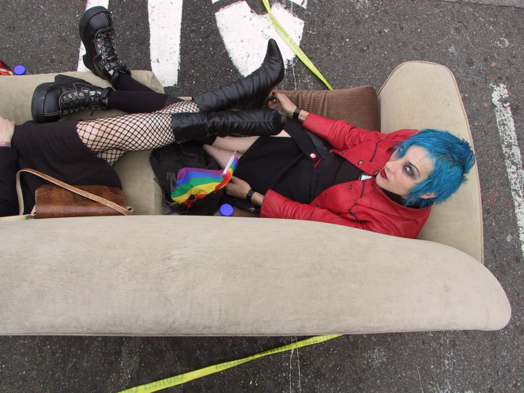 post-awards ceremony, people recline on sofas that have been pulled out into the middle of castro street