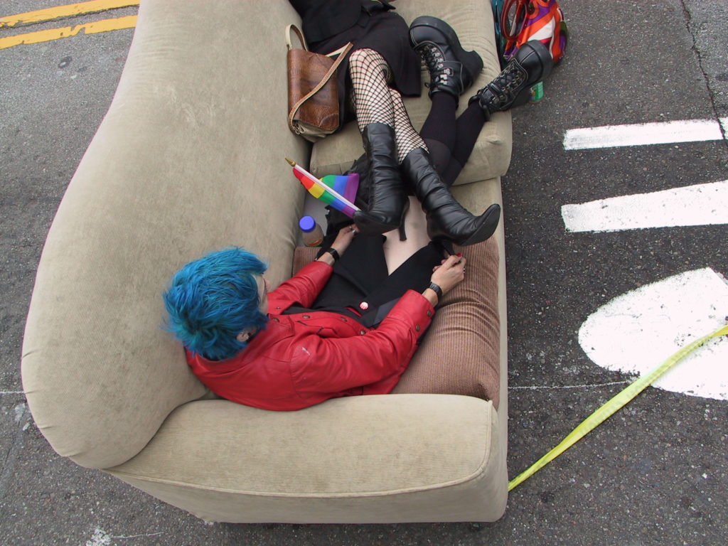 people relax in couches in the middle of castro street