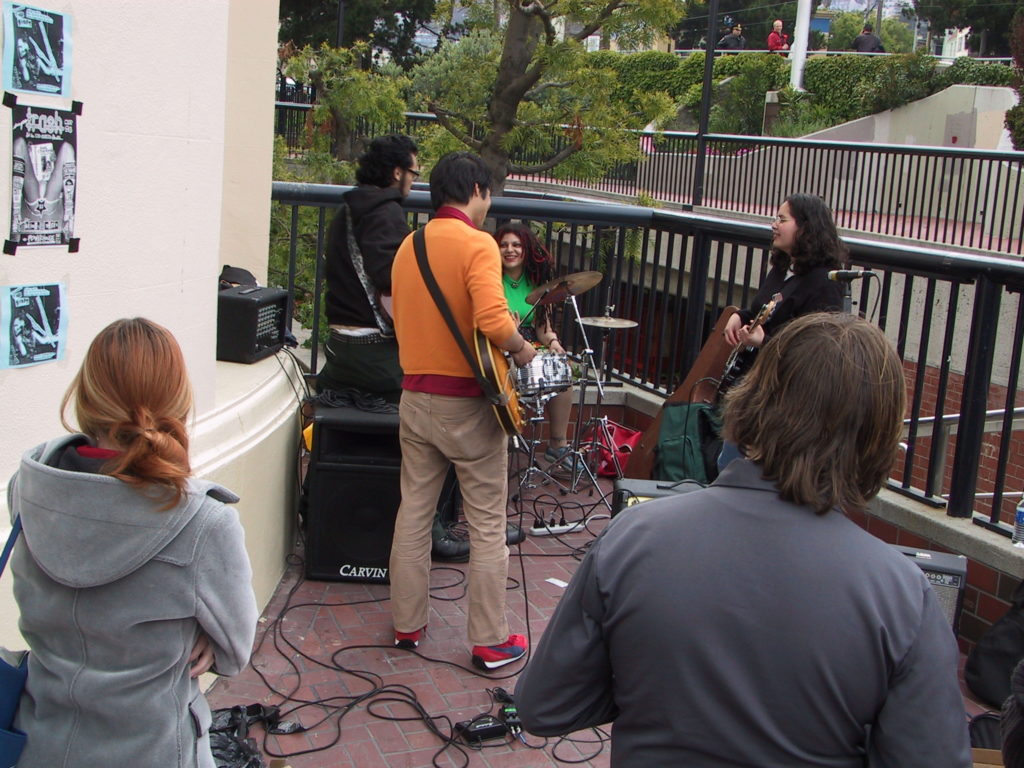 a band has started to perform in harvey milk plaza after the awards ceremony