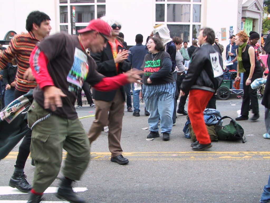 people begin to dance as the deejay starts up in the middle of castro street after the awards ceremony