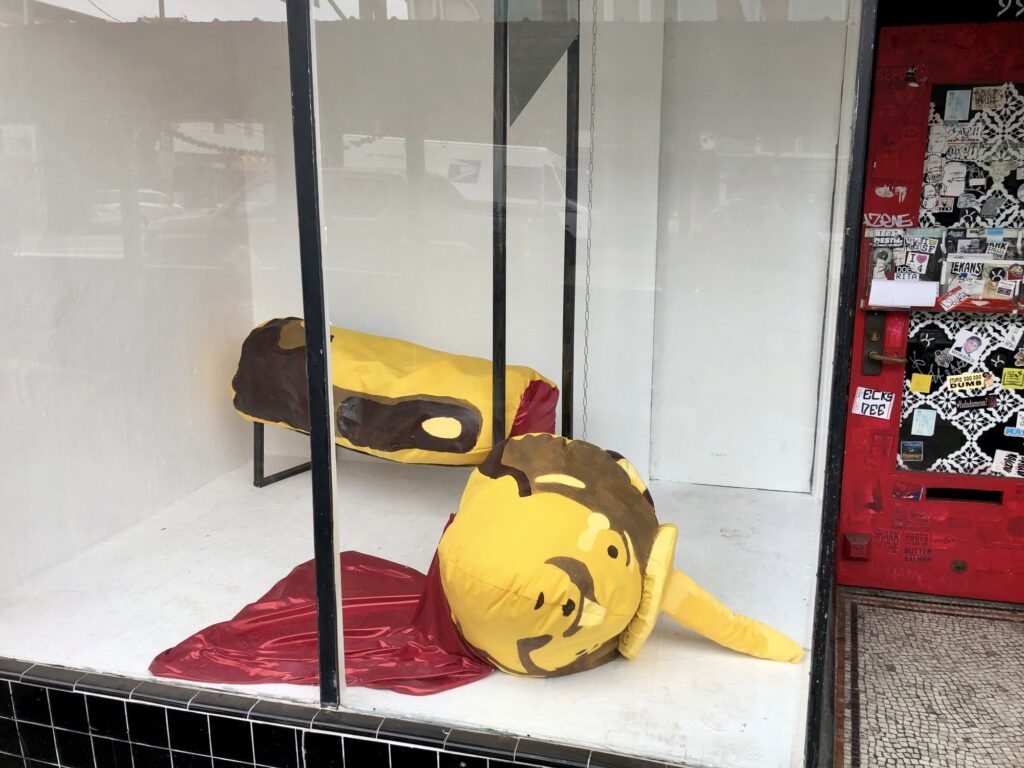 Photograph of a honey bear that has been beheaded by a guillotine